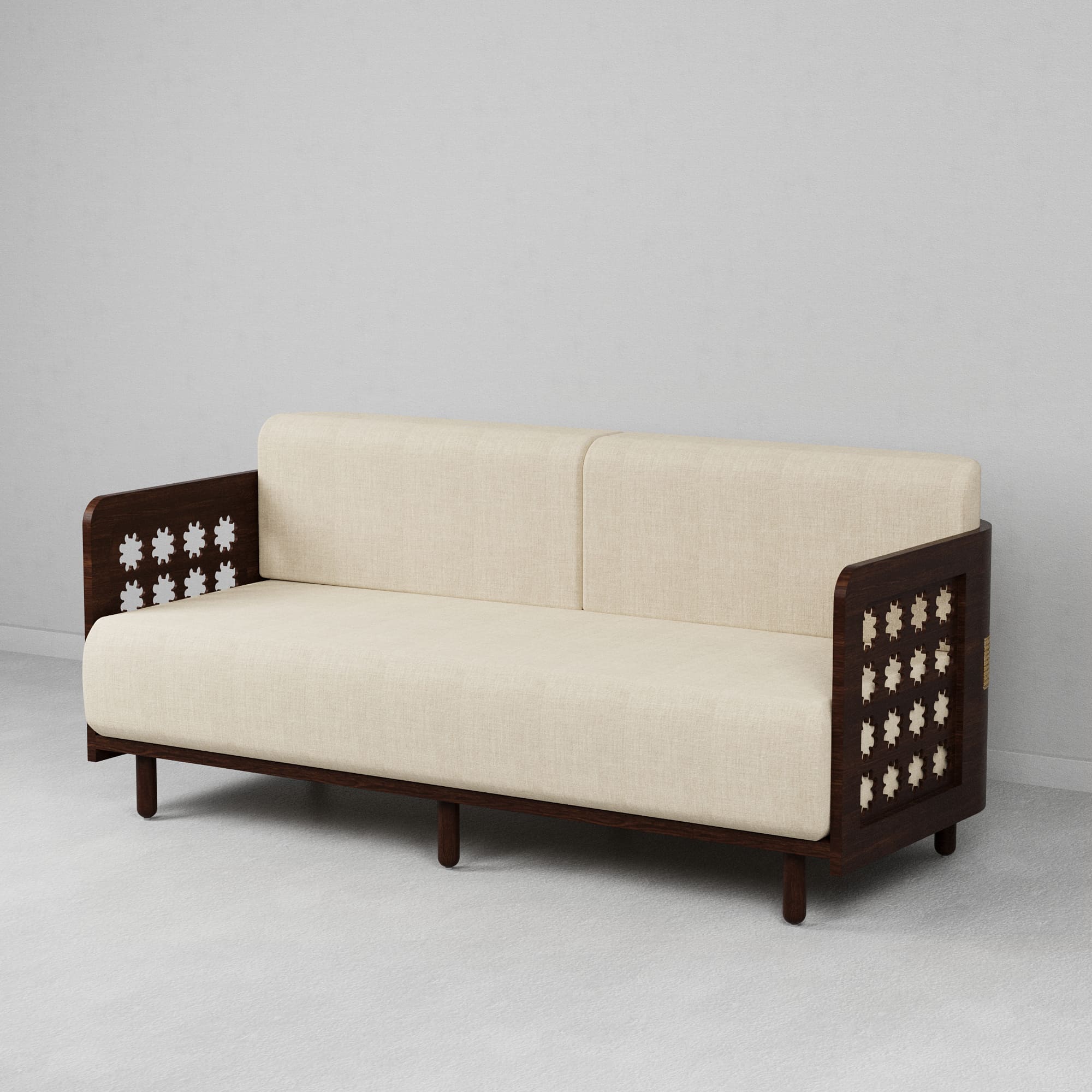 A beige 3-seater sofa with wooden side tables featuring cut-out floral patterns and a cushioned backrest and seat.